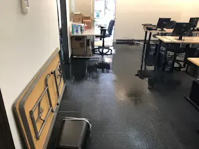 Standing water spread over the floor of an office space